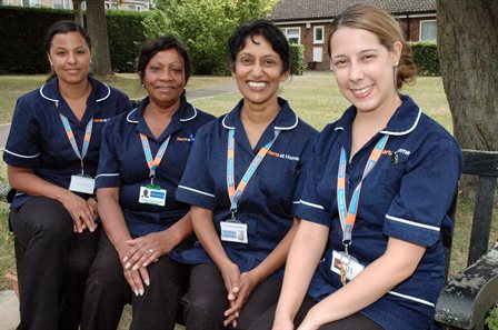 Group of carers smiling on bench 