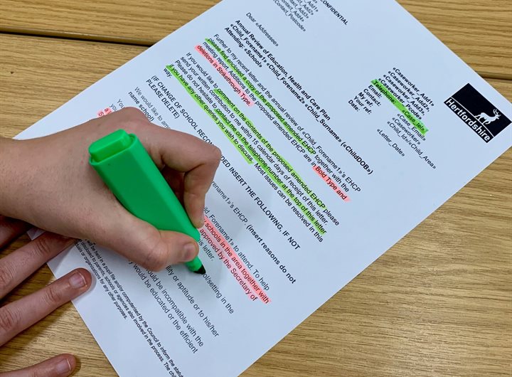 Person completing a highlighter test on a letter