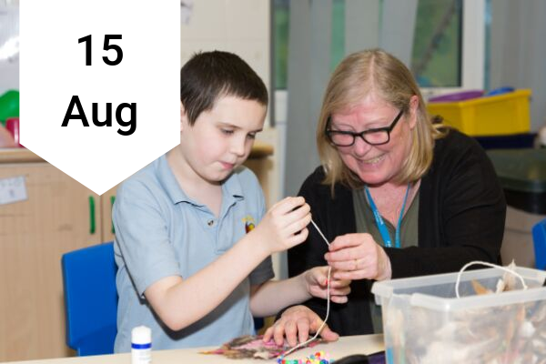 Boy and teacher doing crafts