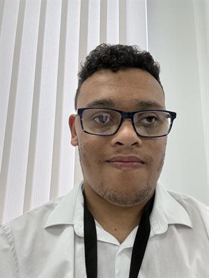 a person smiling in front of a white background