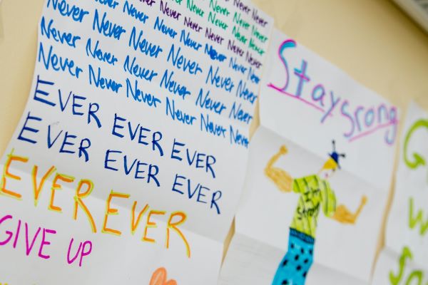 child's drawing with writing reading 'stay strong' and 'never give up'